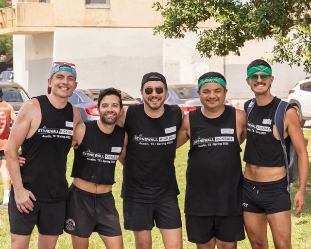 Five players wearing black "Stonewall Kickball - Austin, TX Spring 2025" shirts and athletic shorts stand together on a grassy field, smiling and posing for a group photo; some wear hats, sunglasses, or headbands.